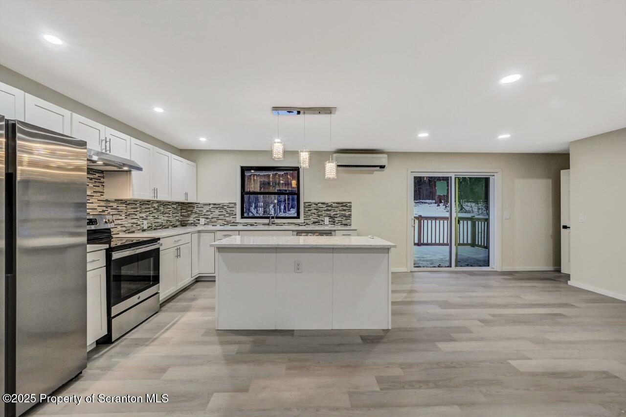 71 Sandy Beach Road Gouldsboro, PA 18424 - Photo 16 of 57 a kitchen with a refrigerator and a stove top oven