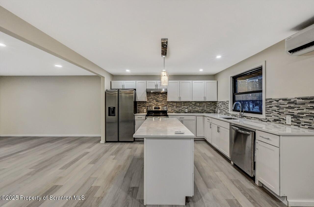 71 Sandy Beach Road Gouldsboro, PA 18424 - Photo 18 of 57 a kitchen with stainless steel appliances granite countertop a refrigerator a stove and a sink