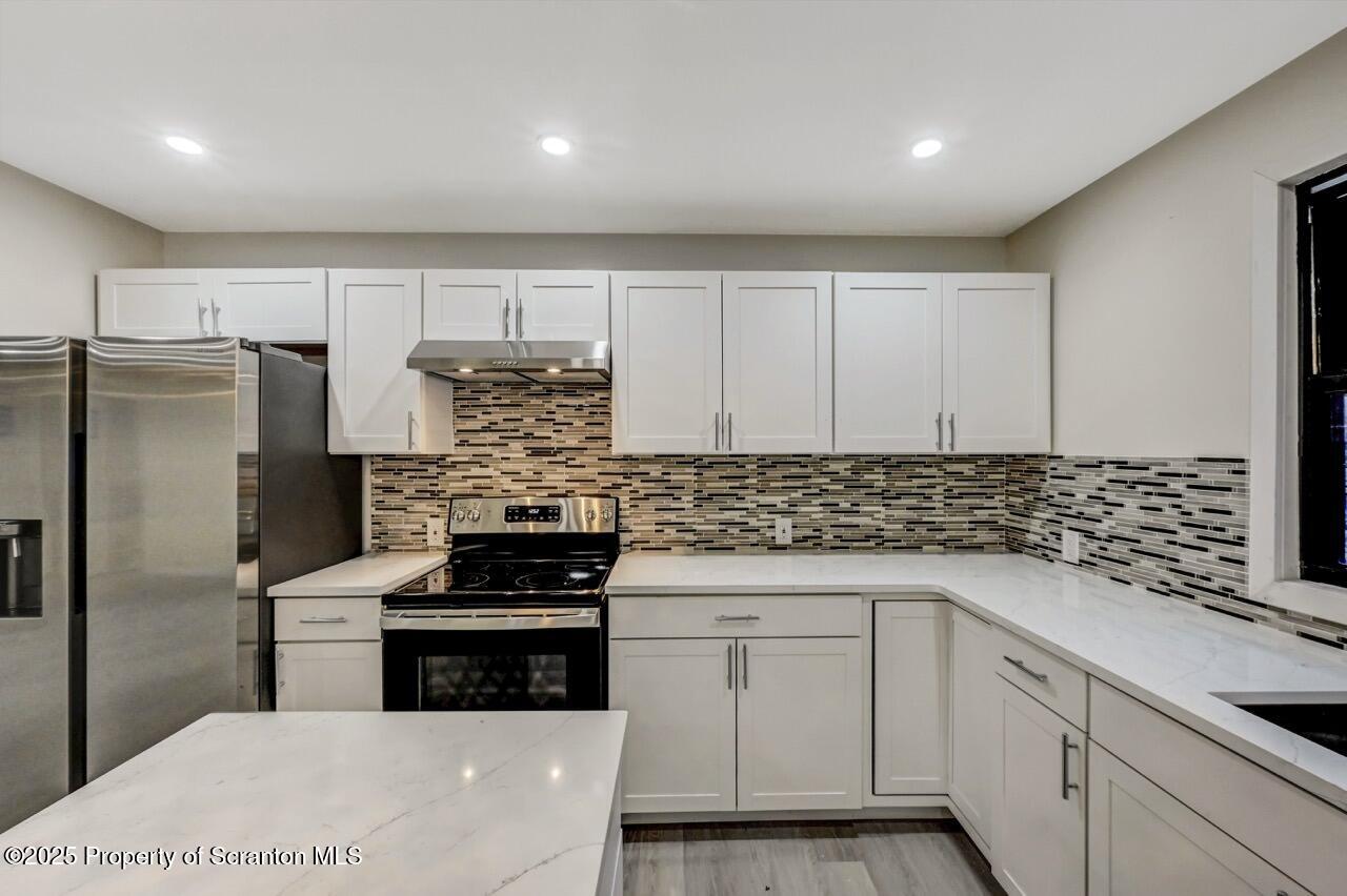 71 Sandy Beach Road Gouldsboro, PA 18424 - Photo 20 of 57 a kitchen with white cabinets sink and stainless steel appliances