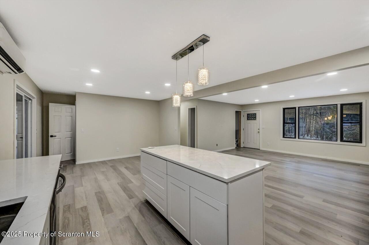 71 Sandy Beach Road Gouldsboro, PA 18424 - Photo 21 of 57 a view of an empty room with wooden floor and a kitchen