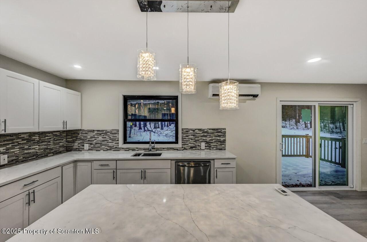 71 Sandy Beach Road Gouldsboro, PA 18424 - Photo 24 of 57 a kitchen with kitchen island granite countertop a sink cabinets and window