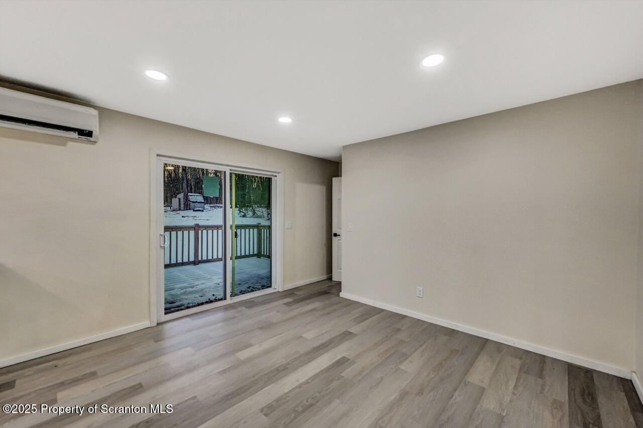 71 Sandy Beach Road Gouldsboro, PA 18424 - Photo 25 of 57 a view of an empty room with wooden floor and a window