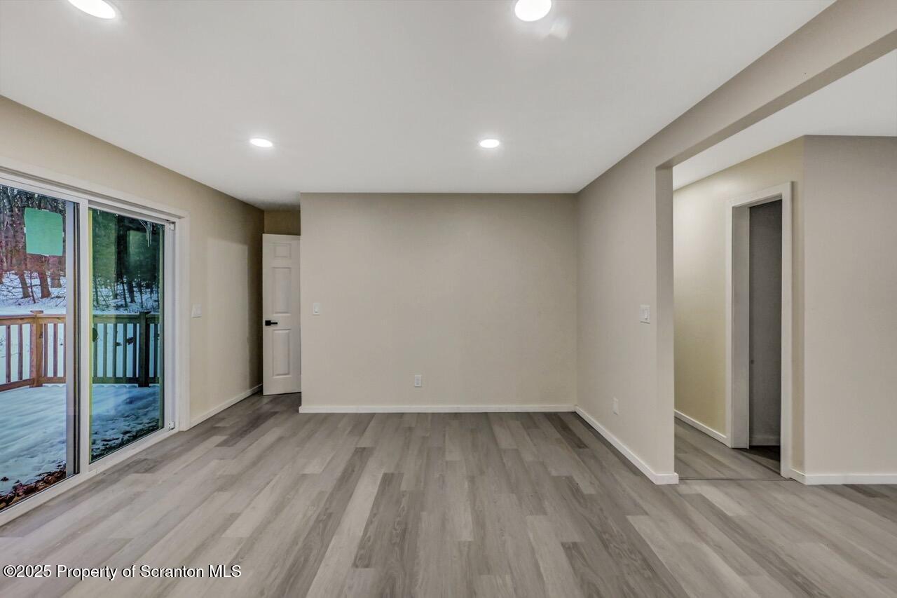 71 Sandy Beach Road Gouldsboro, PA 18424 - Photo 26 of 57 wooden floor in an empty room with a window
