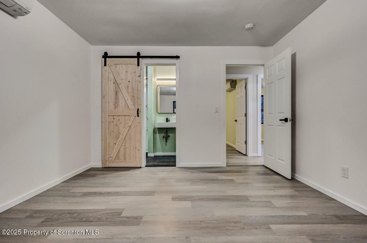 71 Sandy Beach Road Gouldsboro, PA 18424 - Photo 31 of 57 an empty room with wooden floor and mirror