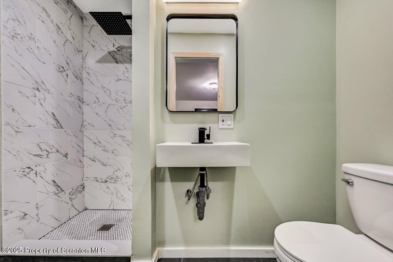 71 Sandy Beach Road Gouldsboro, PA 18424 - Photo 33 of 57 a bathroom with a toilet sink and mirror