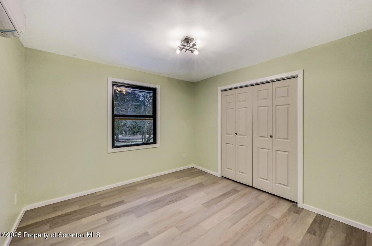 71 Sandy Beach Road Gouldsboro, PA 18424 - Photo 43 of 57 an empty room with wooden floor closet and windows