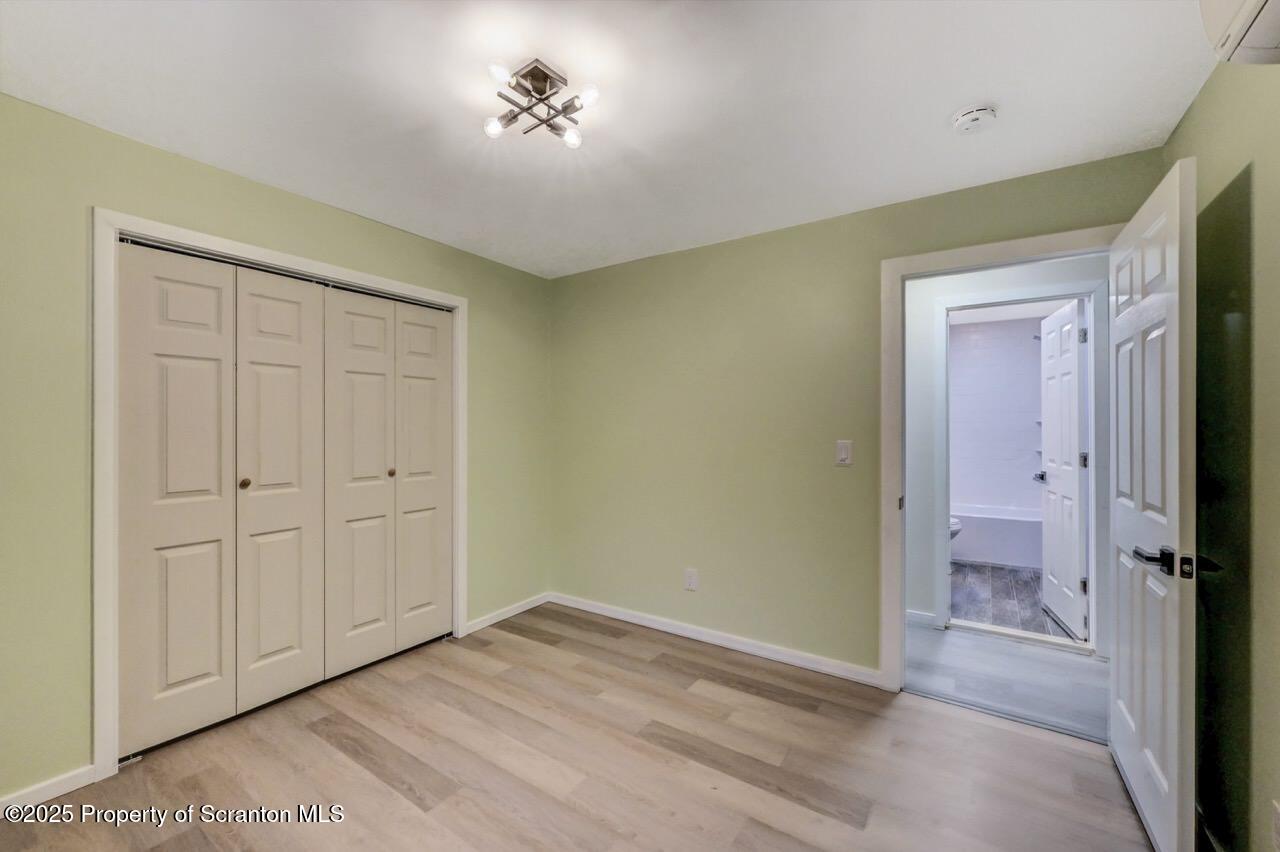 71 Sandy Beach Road Gouldsboro, PA 18424 - Photo 44 of 57 wooden floor in an empty room with a bathroom