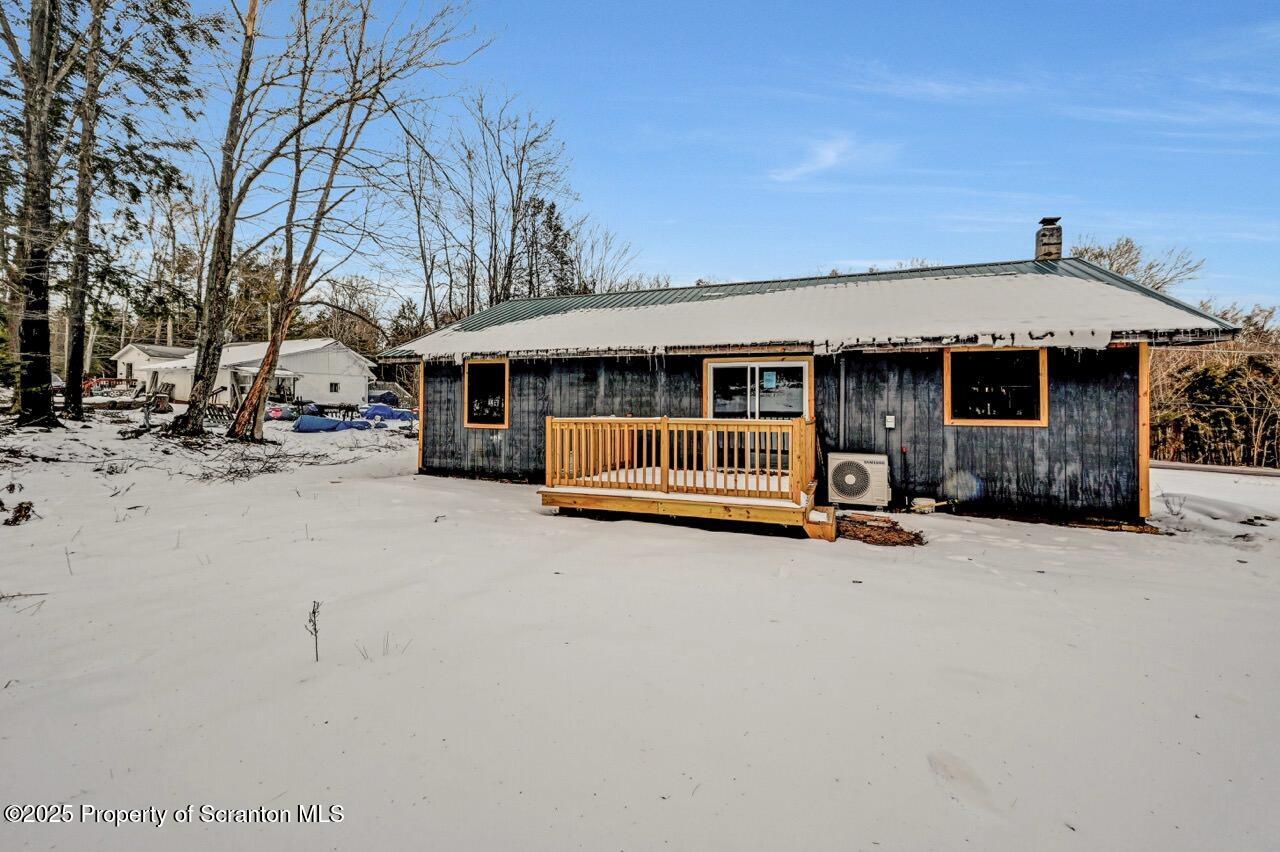71 Sandy Beach Road Gouldsboro, PA 18424 - Photo 54 of 57 a view of a house with a yard covered in snow