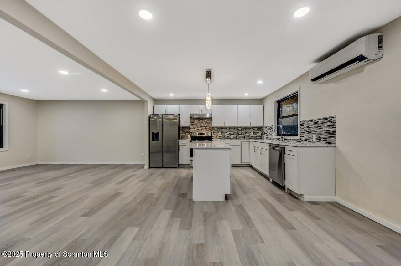71 Sandy Beach Road Gouldsboro, PA 18424 - Photo 9 of 57 a kitchen with stainless steel appliances a refrigerator sink and cabinets