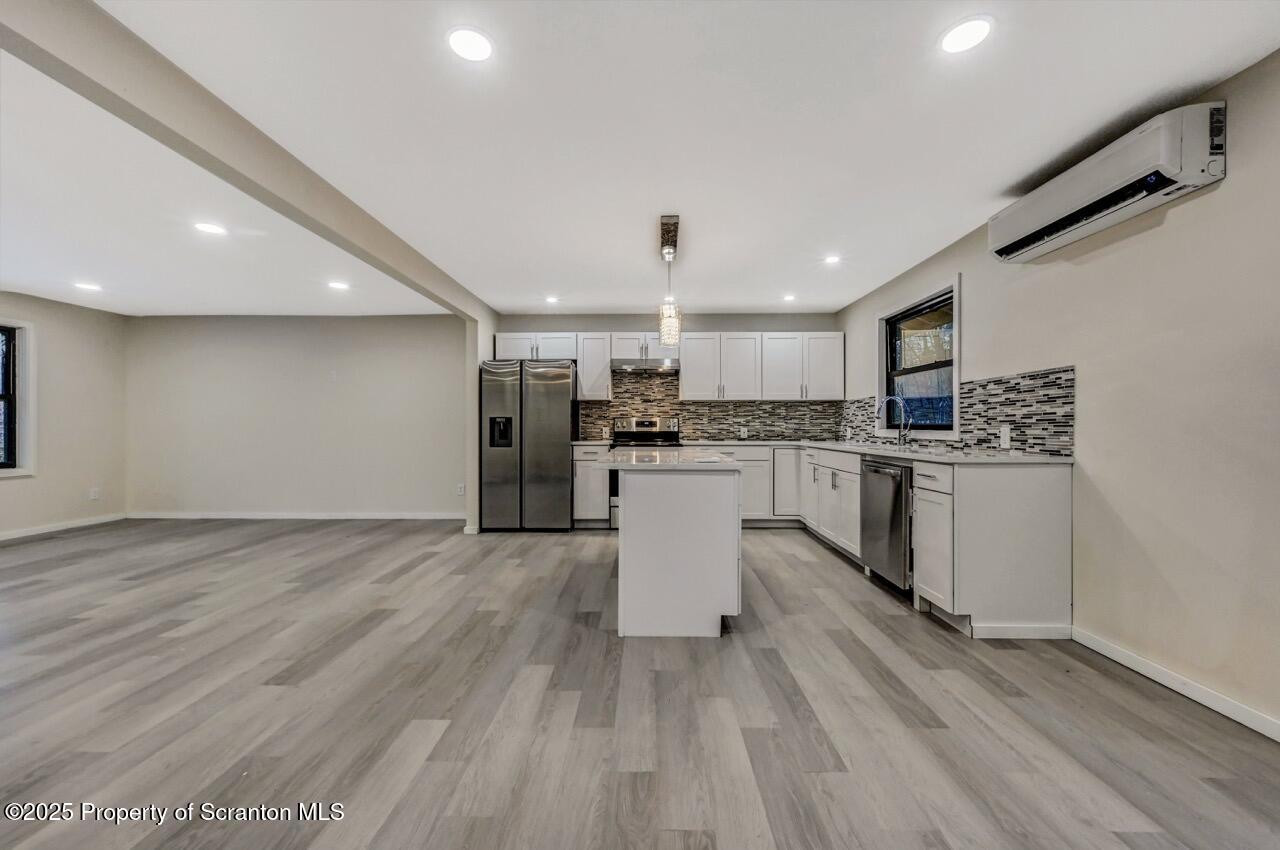 71 Sandy Beach Road Gouldsboro, PA 18424 - Photo 10 of 57 a kitchen with white cabinets stainless steel appliances and sink