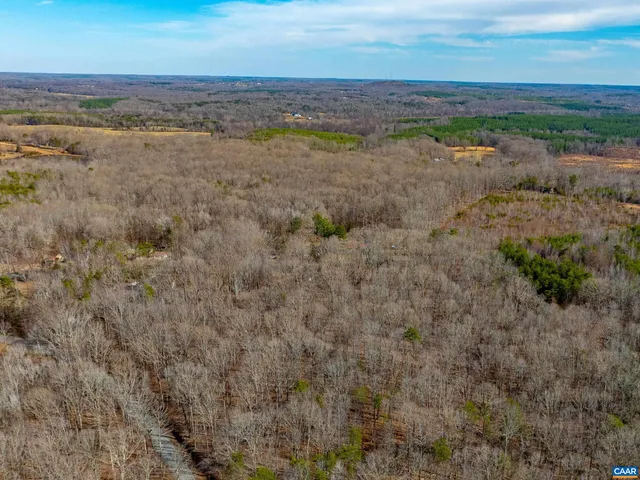 a view of a field with an ocean