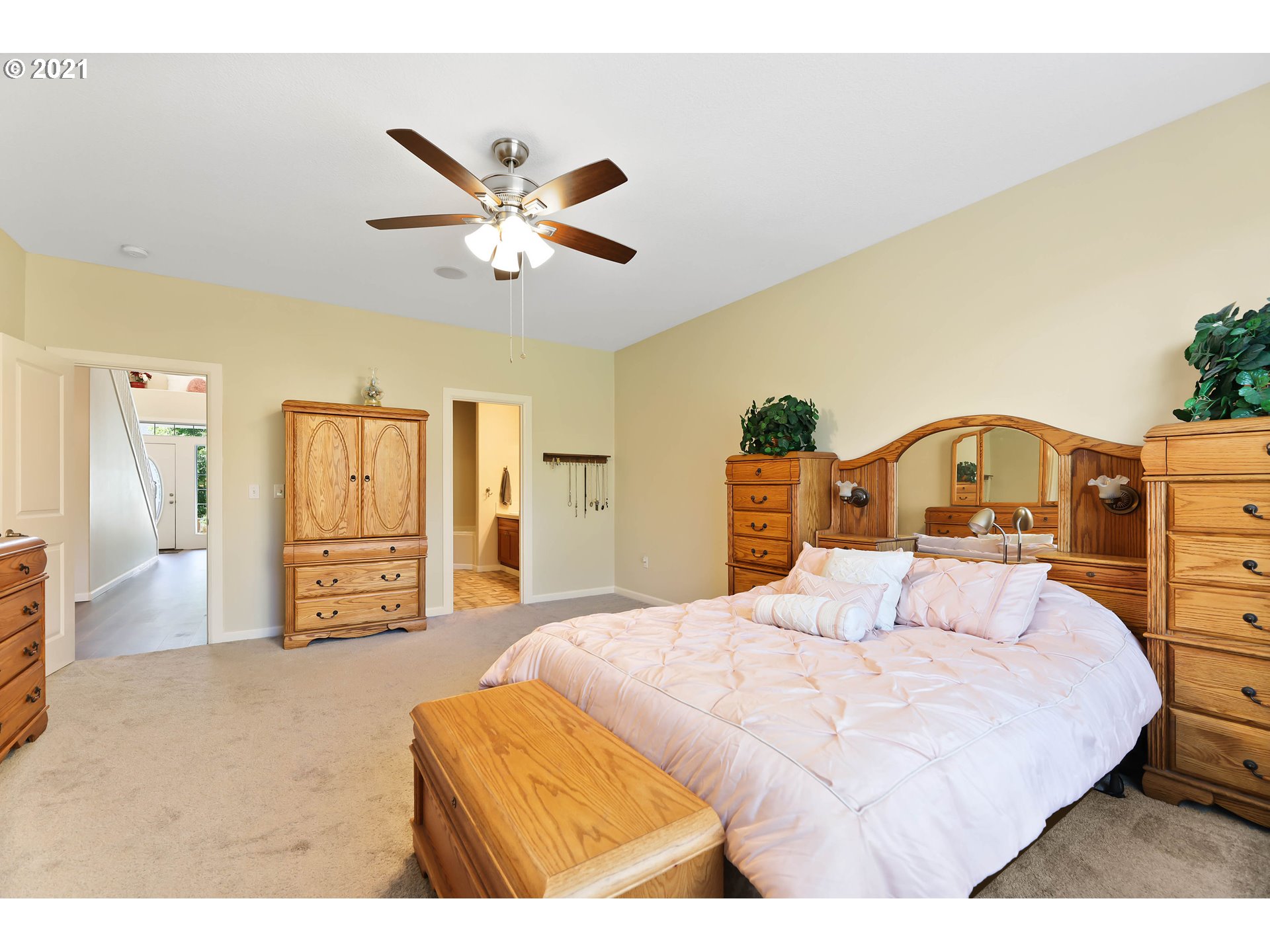 907 North 9th Way Ridgefield, WA 98642 - Photo 16 of 32 a bedroom with a large bed and a chandelier