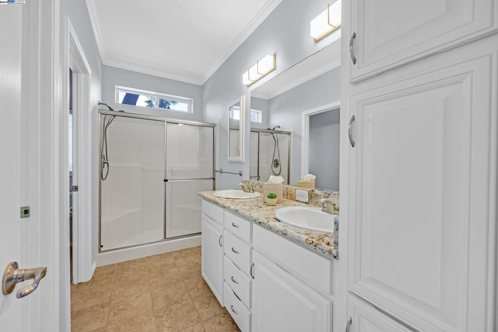 3263 Vineyard Avenue Pleasanton, CA 94566 - Photo 6 of 14 a bathroom with a granite countertop sink a mirror and a shower