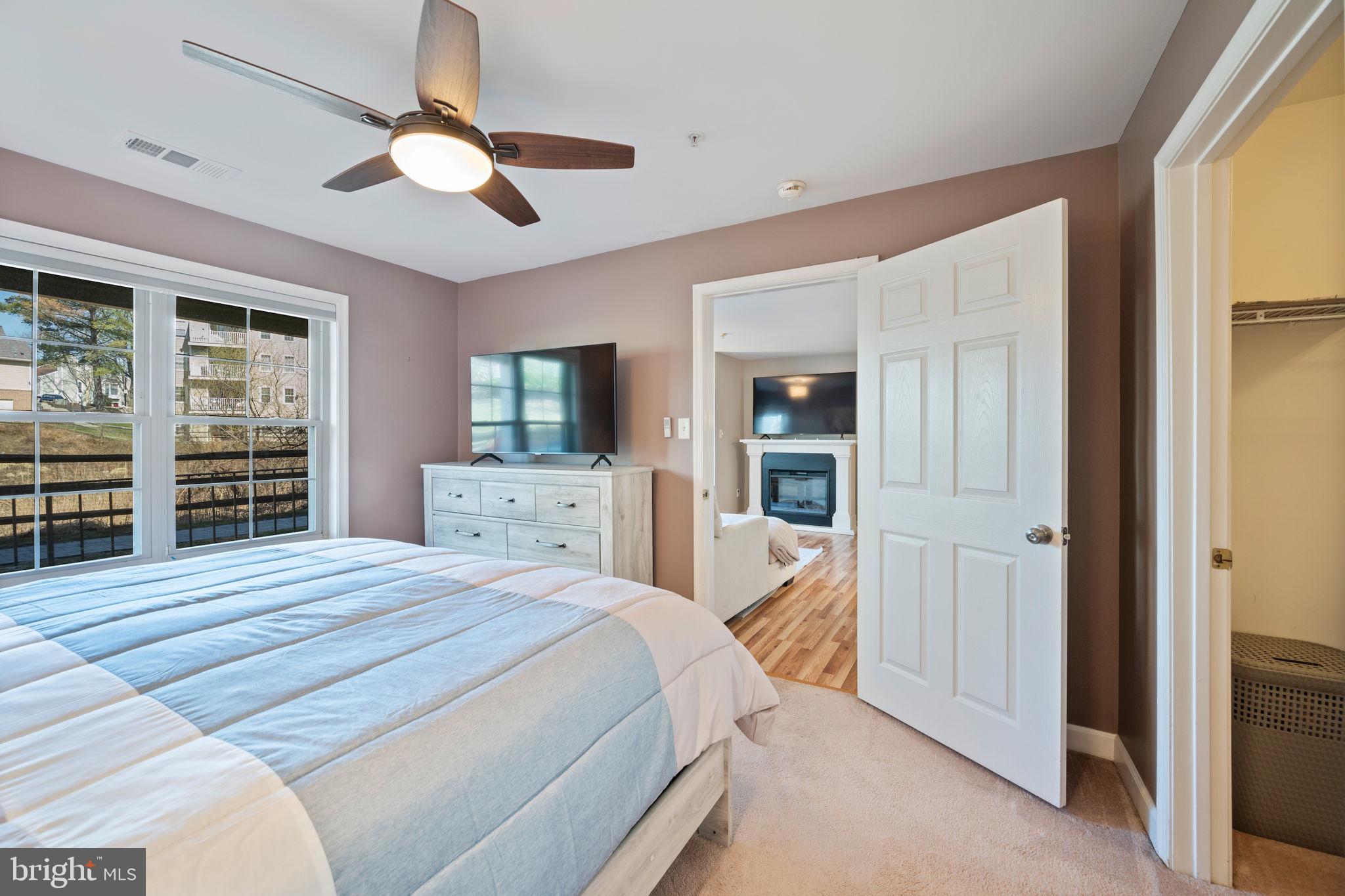 2322 Falls Gable Lane, Unit N Baltimore, MD 21209 - Photo 16 of 44 a bedroom with a bed and a flat screen tv