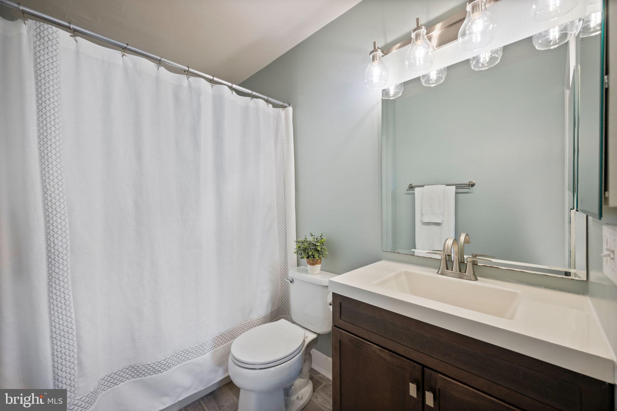 2322 Falls Gable Lane, Unit N Baltimore, MD 21209 - Photo 19 of 44 a bathroom with a sink a toilet and a mirror