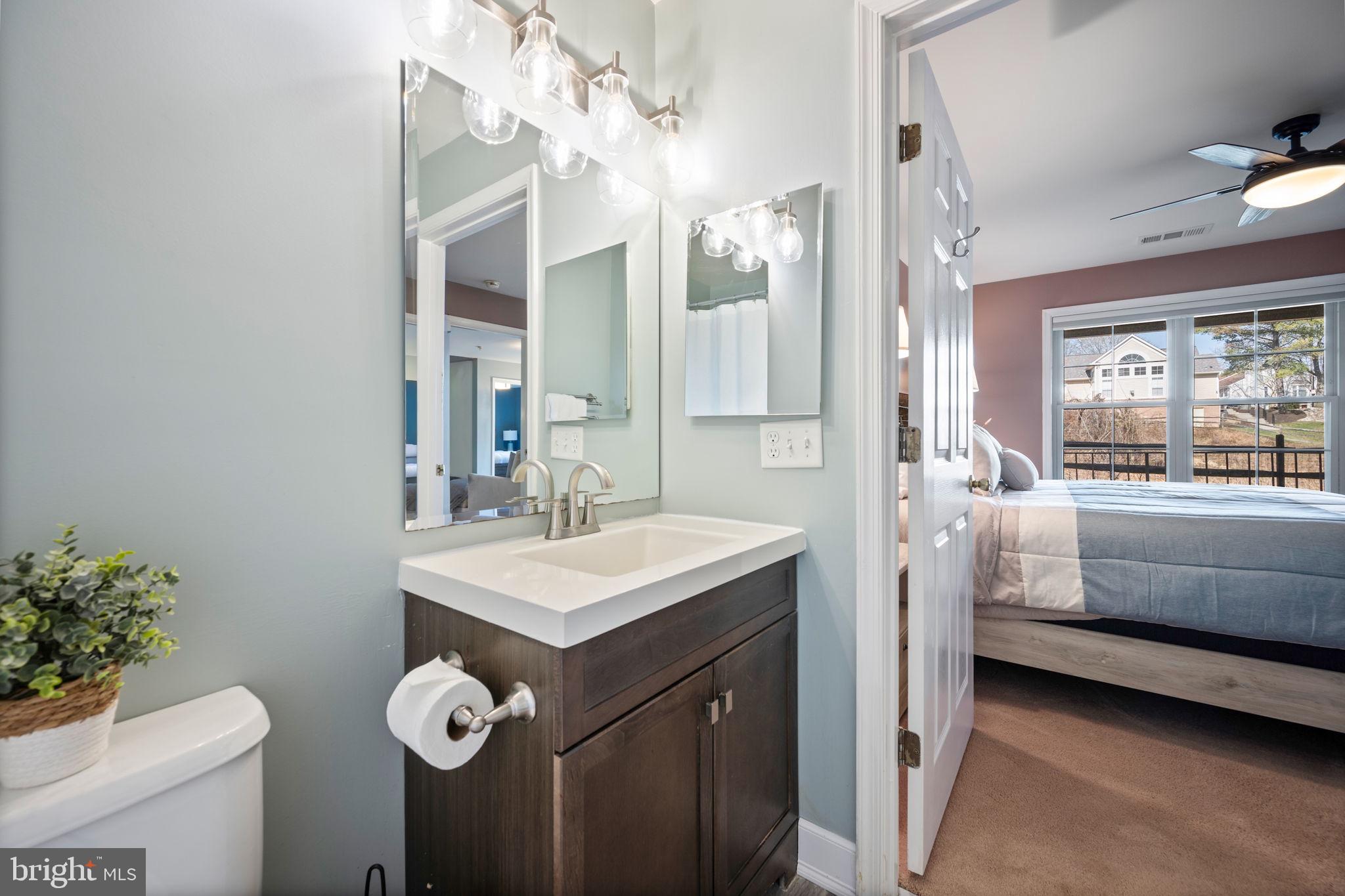 2322 Falls Gable Lane, Unit N Baltimore, MD 21209 - Photo 21 of 44 a bathroom with a sink vanity mirror and toilet
