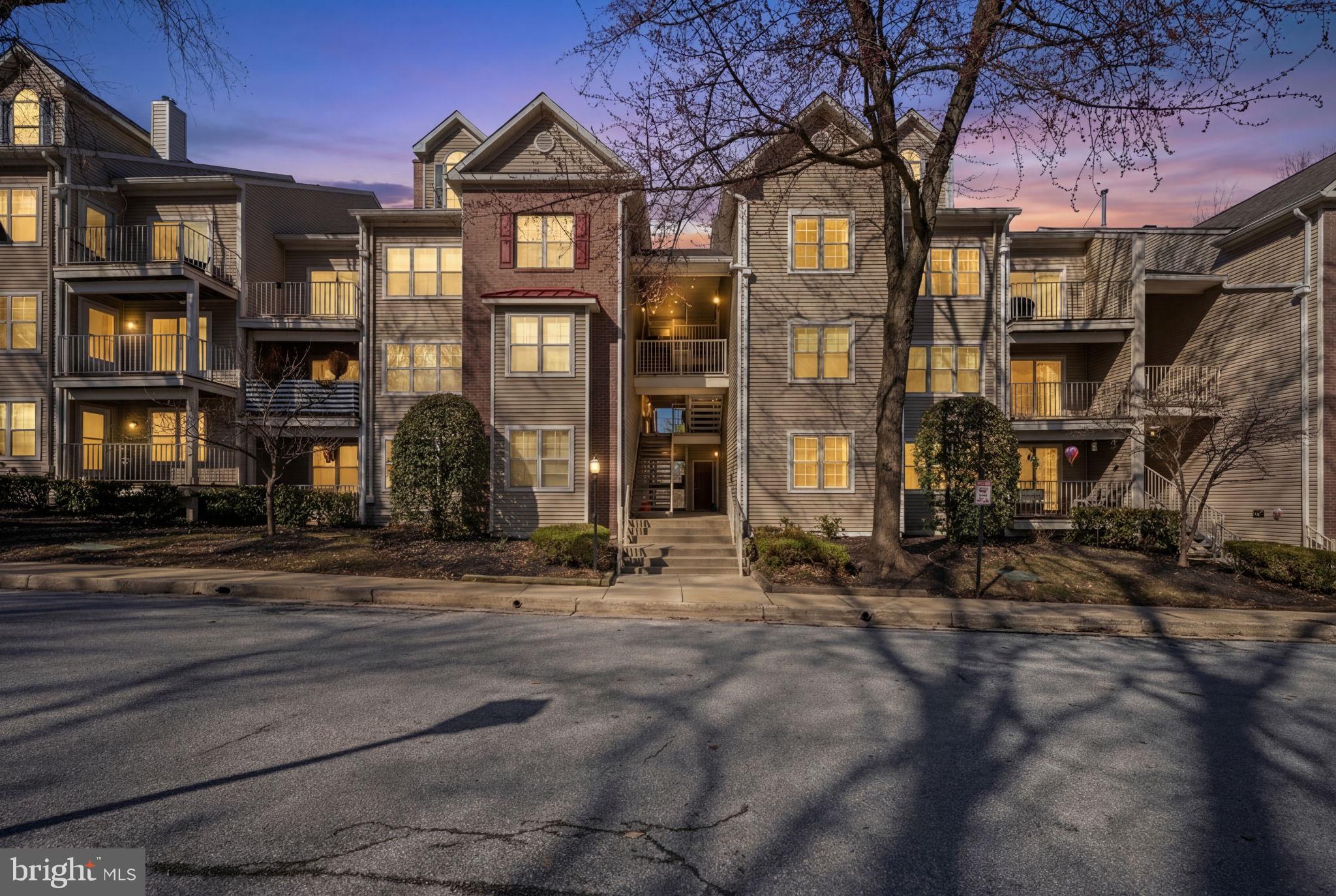 2322 Falls Gable Lane, Unit N Baltimore, MD 21209 - Photo 34 of 44 a front view of a residential apartment building with a yard