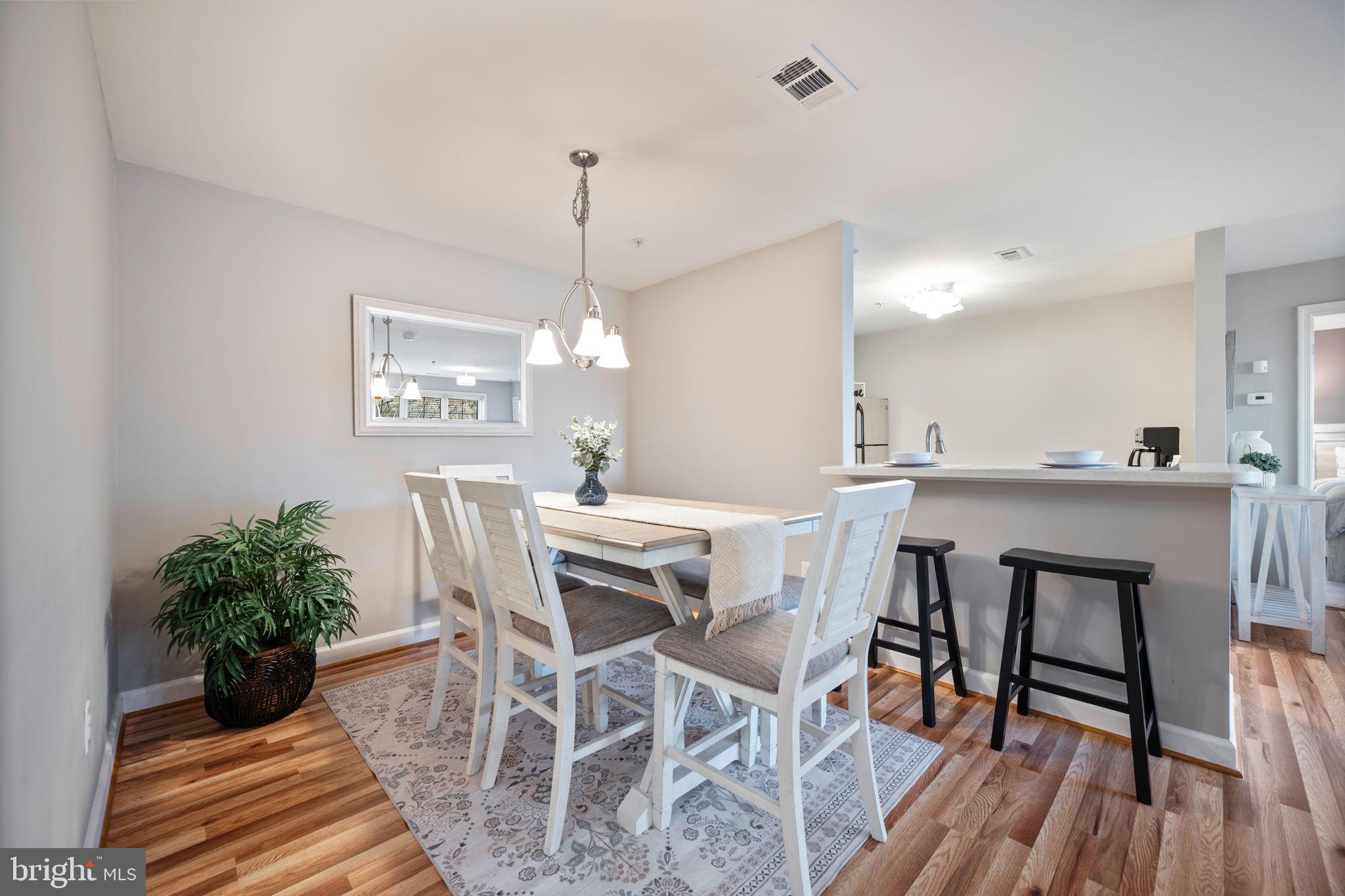 2322 Falls Gable Lane, Unit N Baltimore, MD 21209 - Photo 5 of 44 a view of a dining room with furniture and wooden floor
