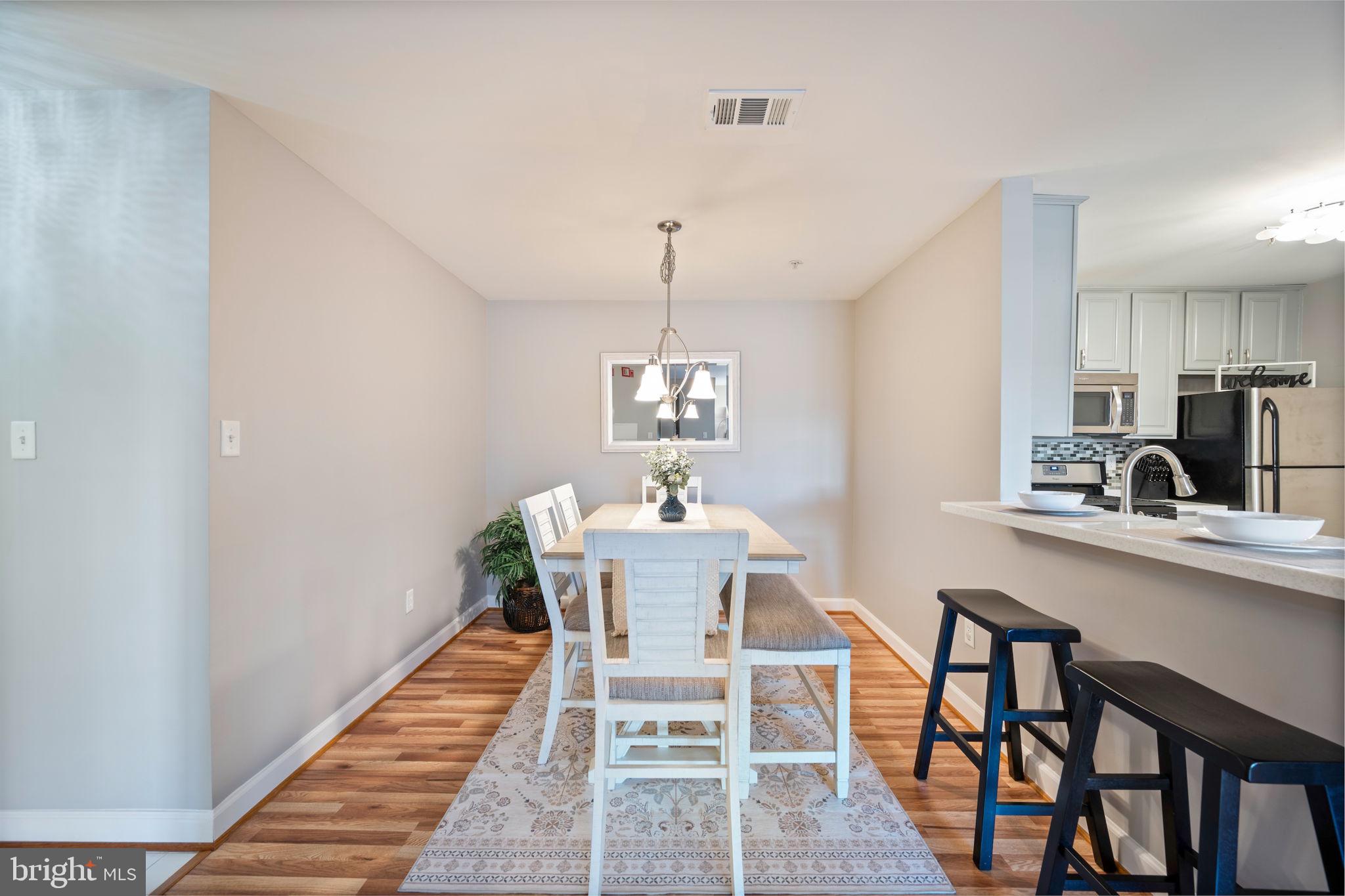 2322 Falls Gable Lane, Unit N Baltimore, MD 21209 - Photo 6 of 44 a view of a dining room with furniture window and wooden floor