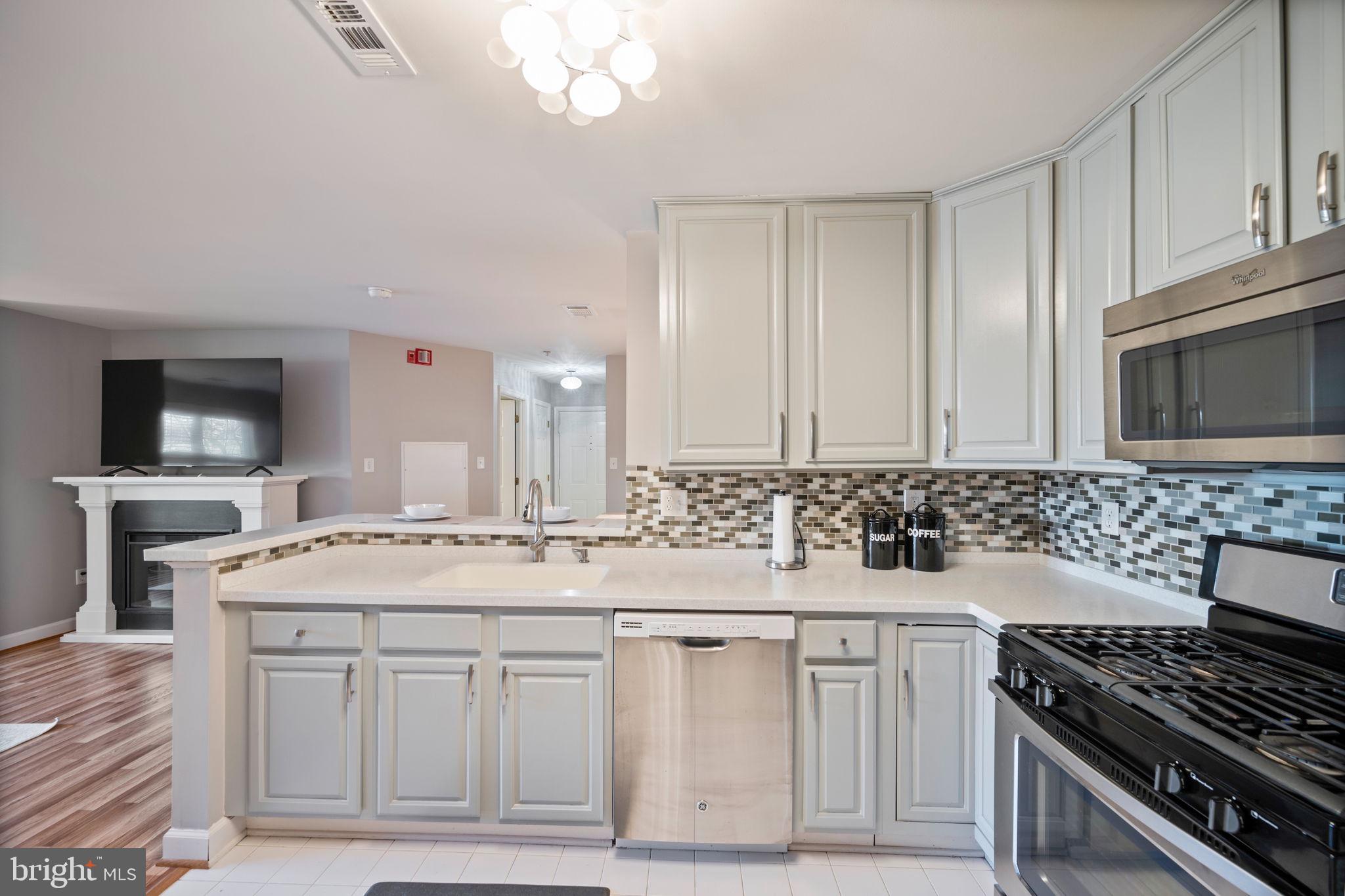 2322 Falls Gable Lane, Unit N Baltimore, MD 21209 - Photo 10 of 44 a kitchen with stainless steel appliances granite countertop a stove and a sink