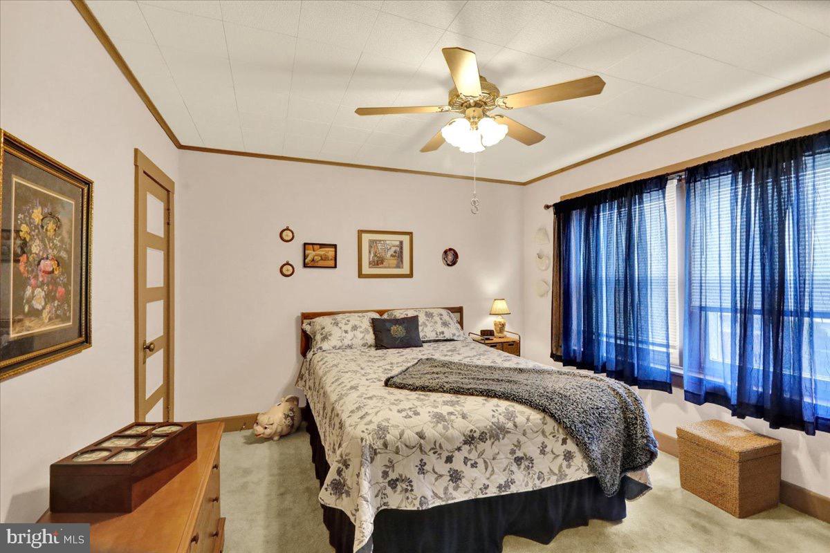 375 Sunset Road Reading, PA 19611 - Photo 11 of 23 a bedroom with a bed and a chandelier