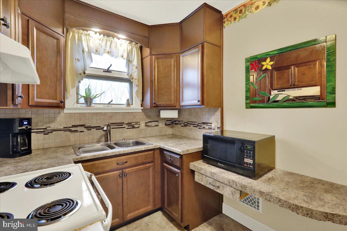 375 Sunset Road Reading, PA 19611 - Photo 5 of 23 a kitchen with a sink and a stove top oven