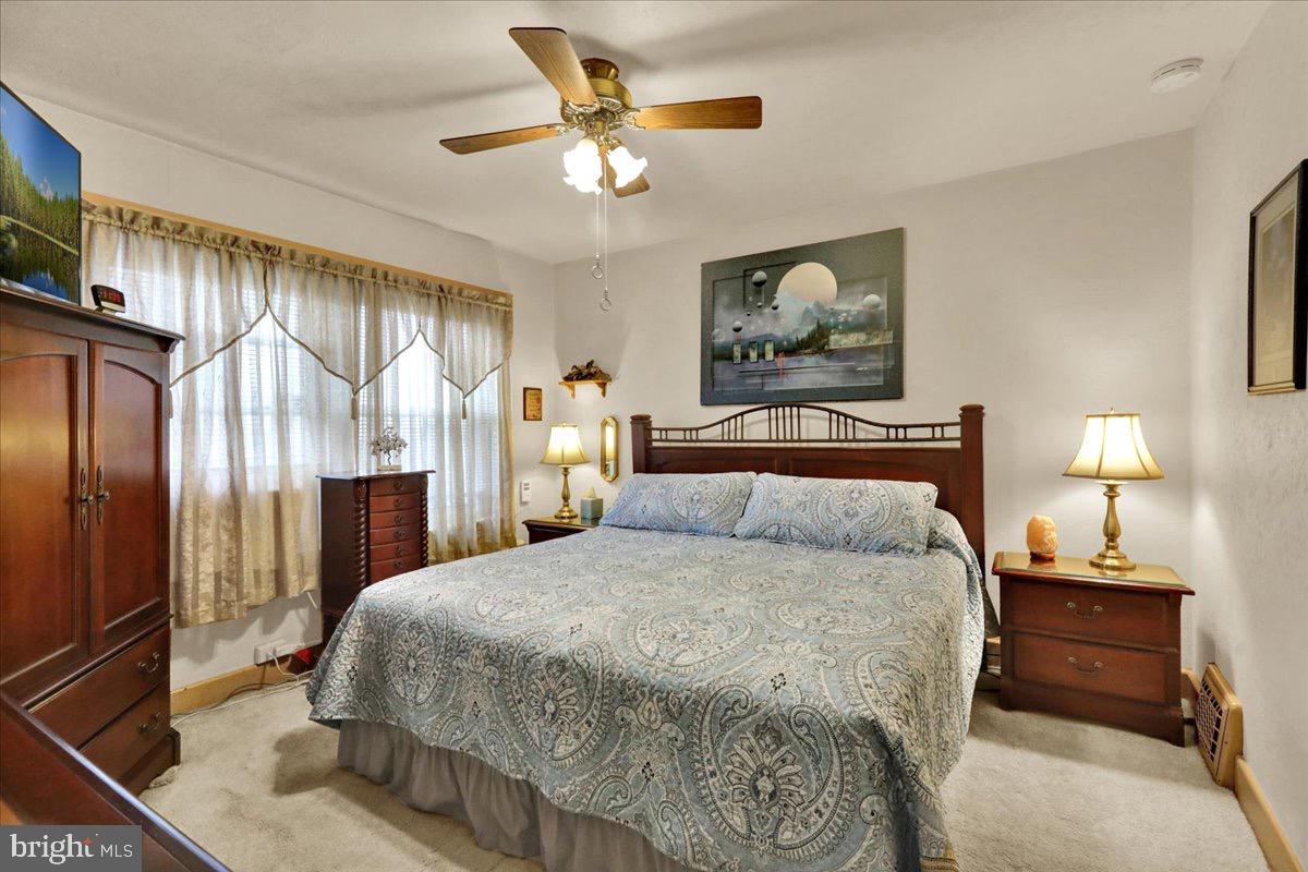 375 Sunset Road Reading, PA 19611 - Photo 9 of 23 a bedroom with a bed and a chandelier