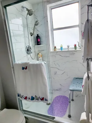 a bathroom with a sink toilet and window