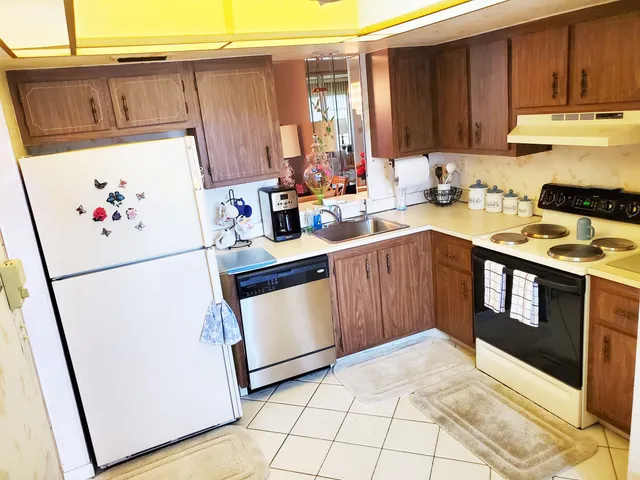 a kitchen with stainless steel appliances a stove a refrigerator sink and cabinets