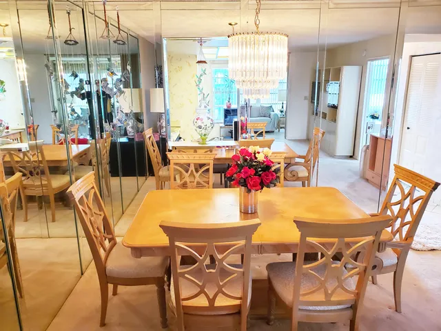 a view of a dining room with furniture and a chandelier