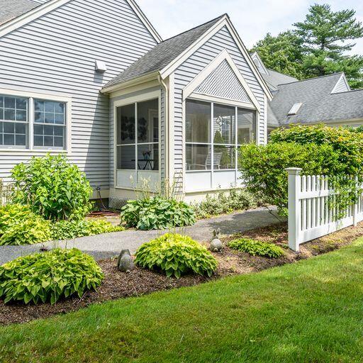 4 Red Cedar Road Mashpee, MA 02649 - Photo 1 of 25 a front view of a house with a yard and potted plants