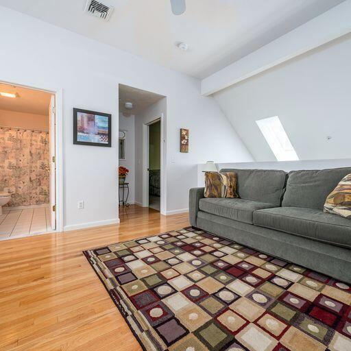 4 Red Cedar Road Mashpee, MA 02649 - Photo 16 of 25 a living room with a couch and a wooden floor