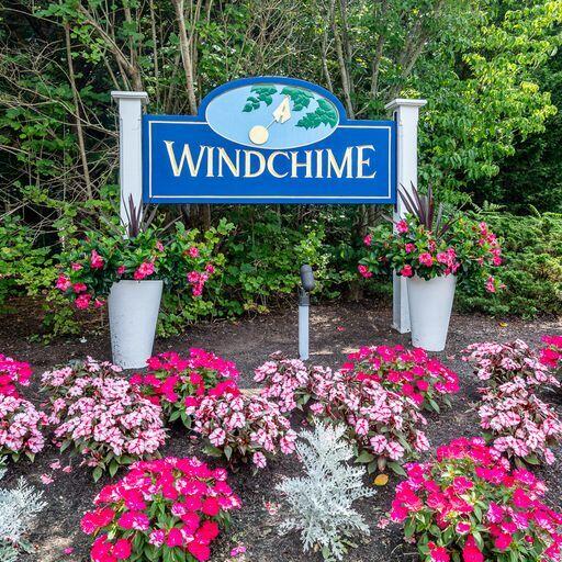 4 Red Cedar Road Mashpee, MA 02649 - Photo 22 of 25 a street sign in front of flowers