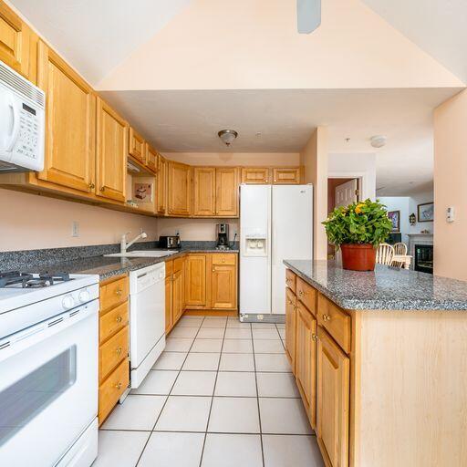 4 Red Cedar Road Mashpee, MA 02649 - Photo 9 of 25 a kitchen with stainless steel appliances granite countertop a sink counter space cabinets and a large window