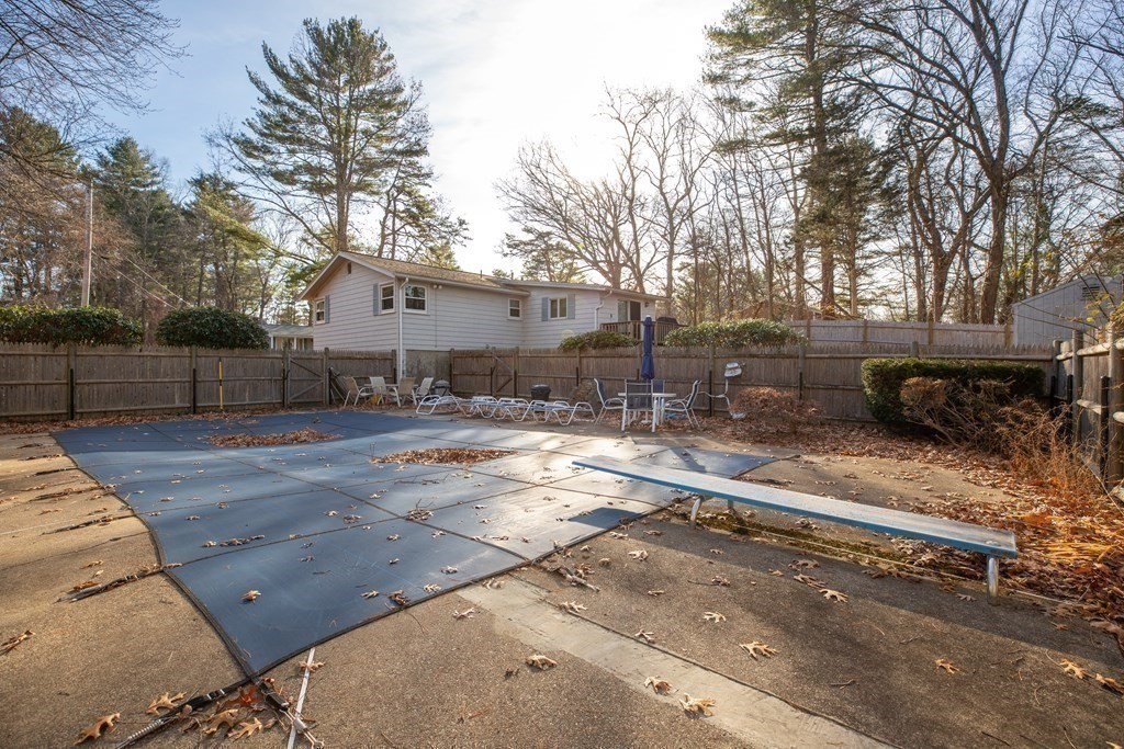 1 Spring Lane Sharon, MA 02067 - Photo 17 of 23 a backyard of a house with fire pit and trees