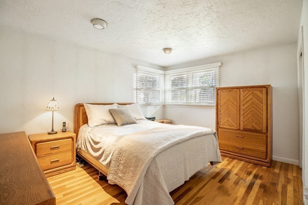 1 Spring Lane Sharon, MA 02067 - Photo 8 of 23 a bedroom with a bed and wooden floor
