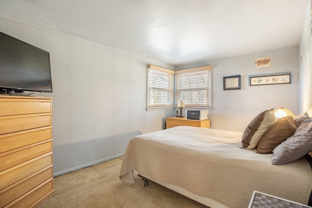 1 Spring Lane Sharon, MA 02067 - Photo 10 of 23 a bedroom with a bed and a flat screen tv