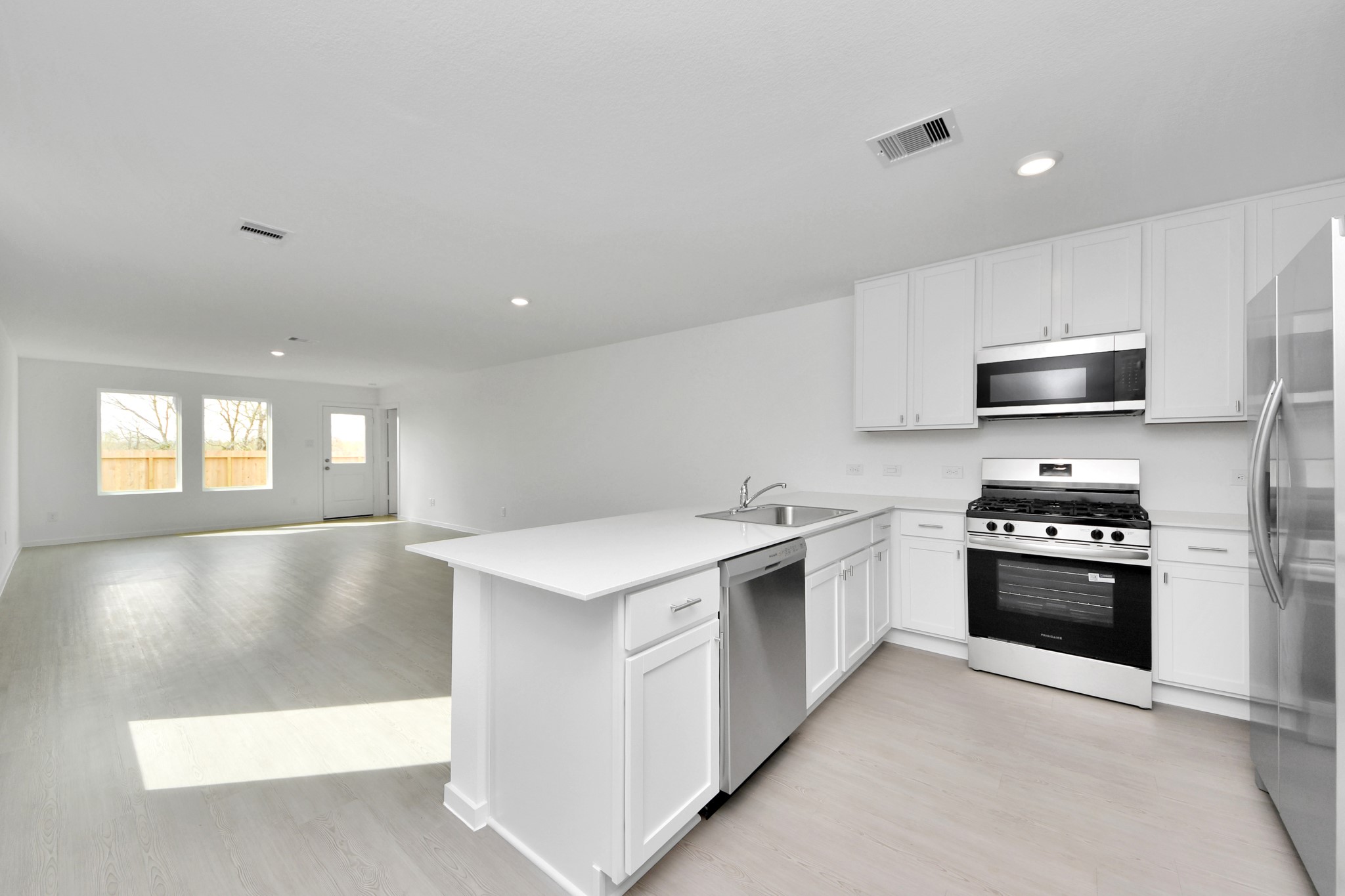 29643 Knollwood Bay Road Waller, TX 77484 - Photo 6 of 35 Stainless steal appliances in large kitchen open to the family room