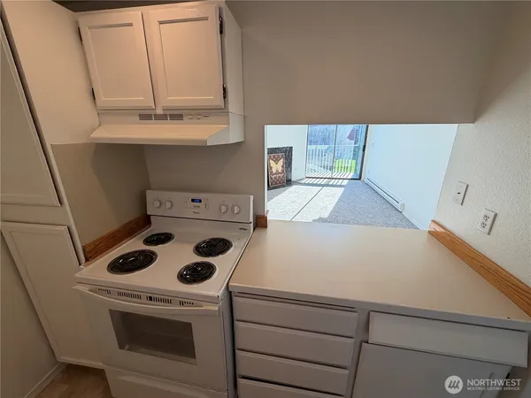 a kitchen with a stove and a microwave