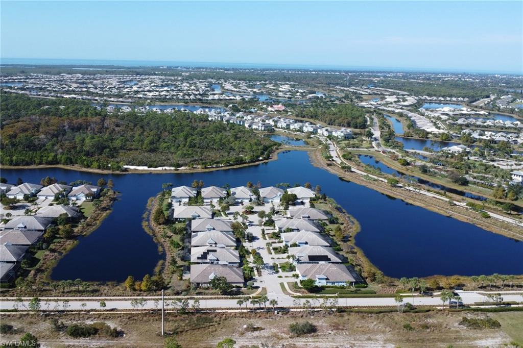 6809 Bequia Way Naples, FL 34113 - Photo 27 of 46 Aerial overview of property's location with a large body of water and nearby suburban area