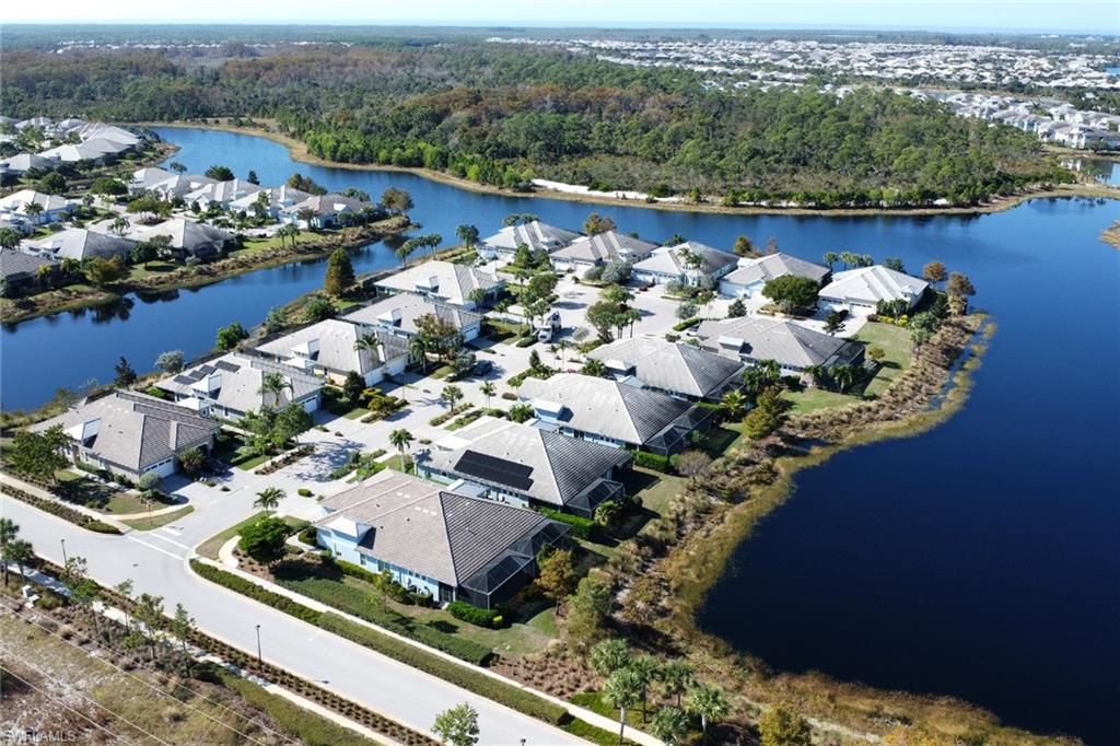 6809 Bequia Way Naples, FL 34113 - Photo 29 of 46 Aerial view of residential area featuring a nearby body of water