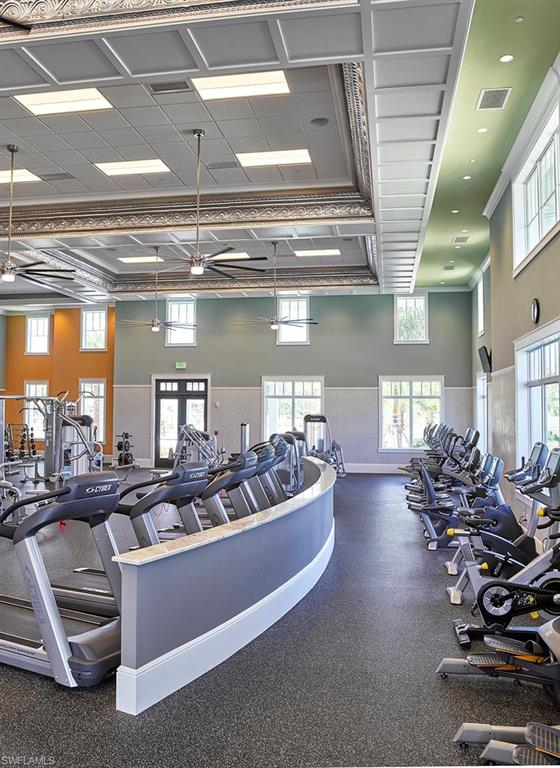6809 Bequia Way Naples, FL 34113 - Photo 44 of 46 Workout area with ornamental molding and a wainscoted wall