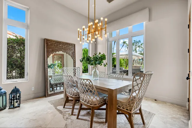 a view of a patio with a table and chairs under an umbrella