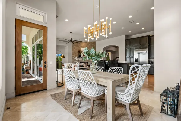a view of a dining room with furniture and chandelier