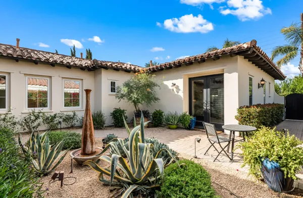 a view of a house with patio outdoor seating and plants