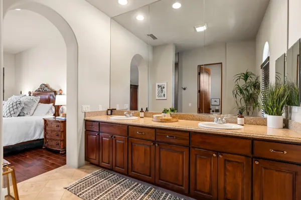 a spacious bathroom with a double vanity sink and a mirror