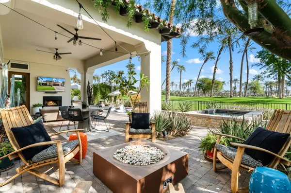 a view of a patio with chairs and table