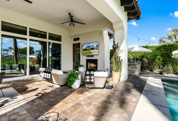 a view of a patio with couches and potted plants