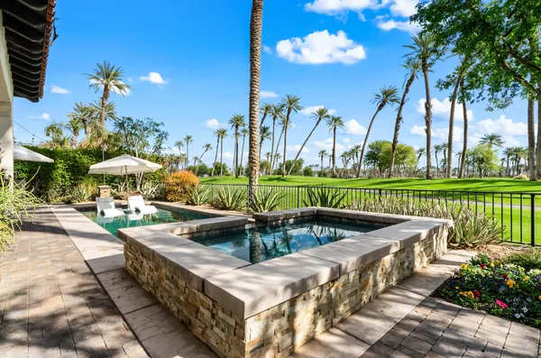 a view of a swimming pool and outdoor seating