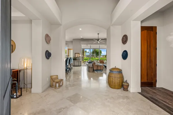 a view of a livingroom with furniture and floor to ceiling window